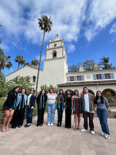 students posing infront of bell tower